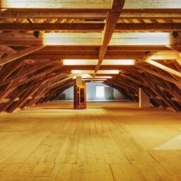 A large room with wooden floors and beams
