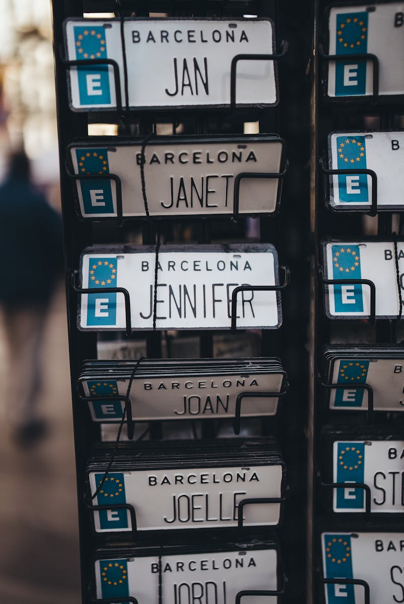 Close-up of personalized name license plates for sale in Barcelona, Spain.