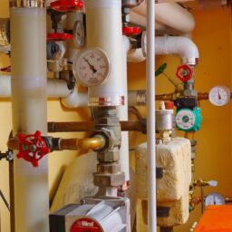 a room with a bunch of pipes and gauges